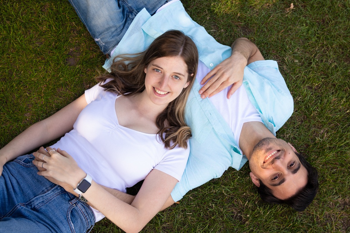 Couples Photoshoot - Young couple lying on the grass looking up in Regents Park London